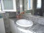 The bathroom is fully laid out with genuine marble tiles
