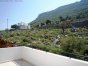 From the staircase landing there is a large terrace with sea, White Mountain, and Drapanos Hill views